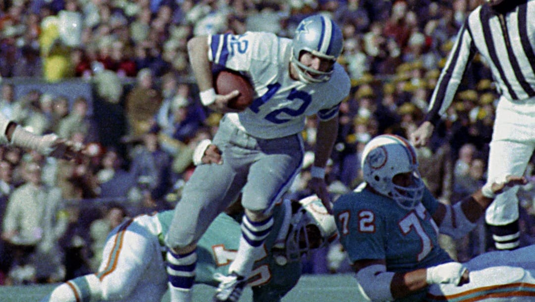 FILE - In this Jan. 16, 1972, file photo, Dallas Cowboys quarterback Roger Staubach (12) tries to escape the grasp of Miami Dolphins defender Jim Riley (70) during Super Bowl VI in New Orleans, La. Staubach, voted the game's most valuable player, completed 12 of 19 passes for 119 yards and two TDs. (AP Photo/File)