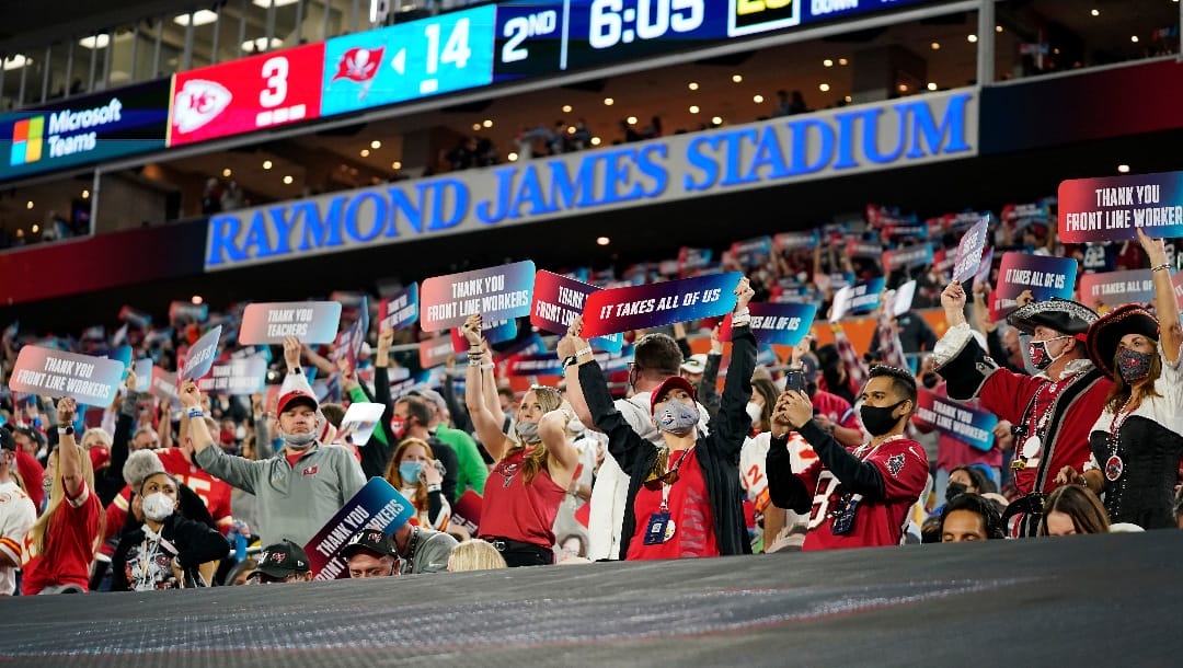 Fans hold up signs honoring front line workers during the first half of the NFL Super Bowl 55 football game between the Tampa Bay Buccaneers and the Kansas City Chiefs, Sunday, Feb. 7, 2021, in Tampa, Fla. The Tampa Bay Buccaneers defeated the Kansas City Chiefs 31-9.