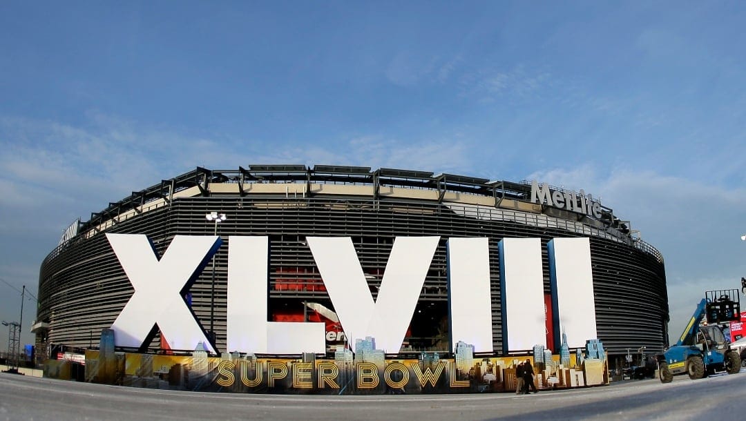 In this Feb. 1, 2014, file photo, a sign for NFL football's Super Bowl XLVIII stands in front of MetLife Stadium in East Rutherford, N.J.