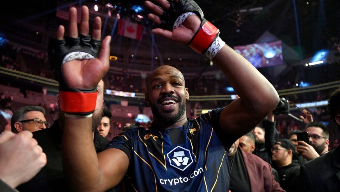 Jon Jones celebrates his victory over Ciryl Gane as he walks from the octagon after the UFC 285 mixed martial arts.