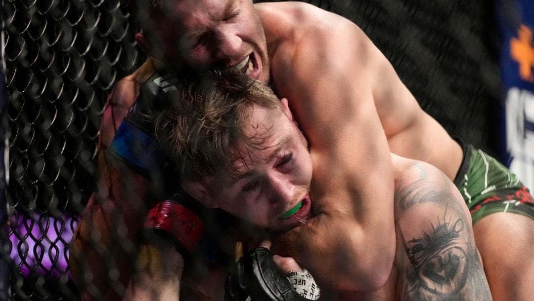 Dricus Du Plessis, top, fights Darren Till during a UFC 282 mixed martial arts middleweight bout Saturday, Dec. 10, 2022.