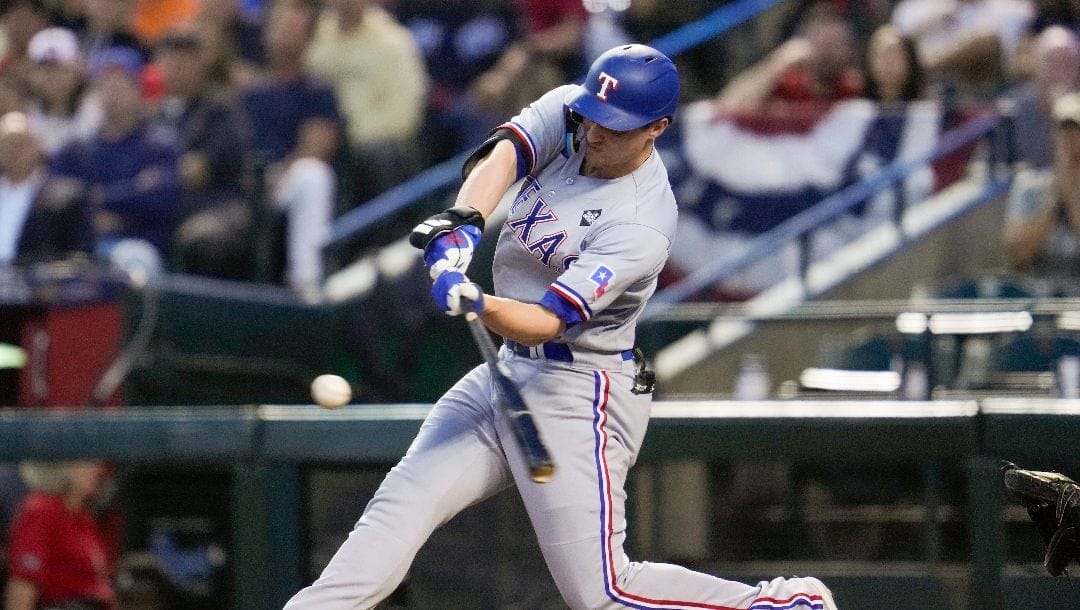 Texas Rangers' Corey Seager hits a two-run home run against the Arizona Diamondbacks during the second inning in Game 4 of the baseball World Series Tuesday, Oct. 31, 2023, in Phoenix.