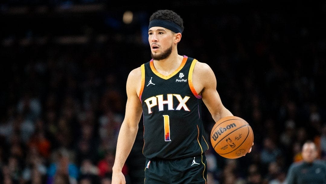 Devin Booker #1 of the Phoenix Suns controls the ball during the first half of the NBA game against the Milwaukee Bucks at Footprint Center on February 06, 2024 in Phoenix, Arizona