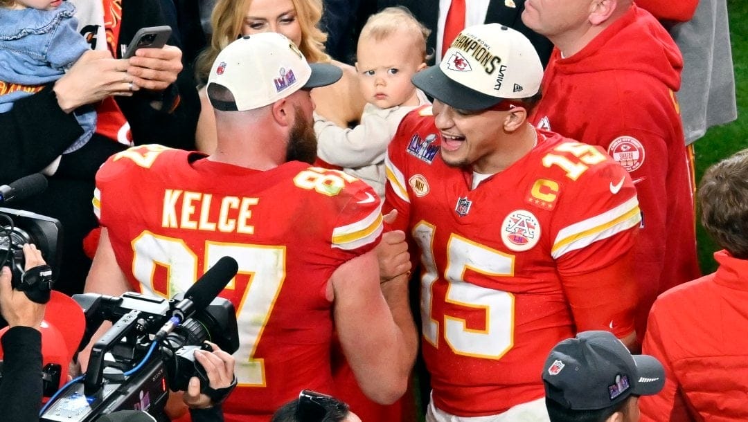 Kansas City Chiefs quarterback Patrick Mahomes (15) and tight end Travis Kelce (87) celebrate their win against the San Francisco 49ers in overtime during the NFL Super Bowl 58 football game Sunday, Feb. 11, 2024, in Las Vegas. The Chiefs won 25-22.