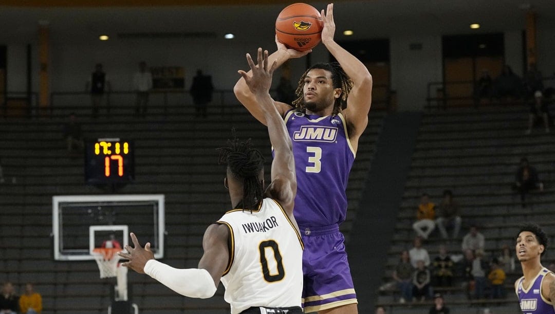James Madison forward T.J. Bickerstaff (3) shoots over the defense of Southern Mississippi forward Victor Iwuakor (0) during the first half of an NCAA college basketball game, Saturday, Jan. 6, 2024, in Hattiesburg, Miss. Southern Mississippi won 81-71.