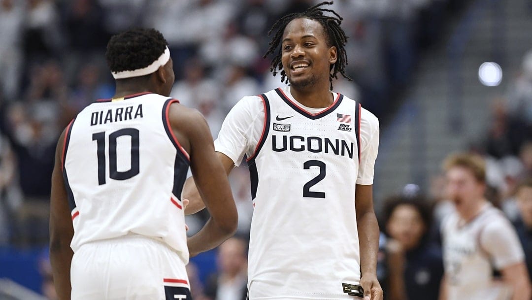 UConn guard Tristen Newton (2) celebrates with UConn guard Hassan Diarra (10) in the second half of an NCAA college basketball game, Saturday, Feb. 17, 2024, in Hartford, Conn.