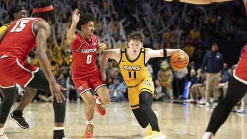 Virginia Commonwealth's Max Shulga (11) defends the ball from Dayton's Javon Bennett (0) during the second half of an NCAA college basketball game Friday, Feb. 9, 2024, in Richmond, Va.