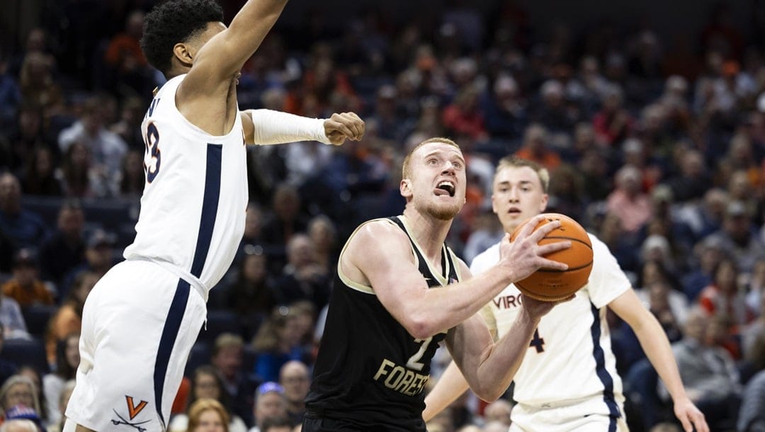 Wake Forest's Cameron Hildreth (2) looks to shoot past Virginia's Ryan Dunn (13) during the first half of an NCAA college basketball game Saturday, Feb. 17, 2024 in Charlottesville, Va.