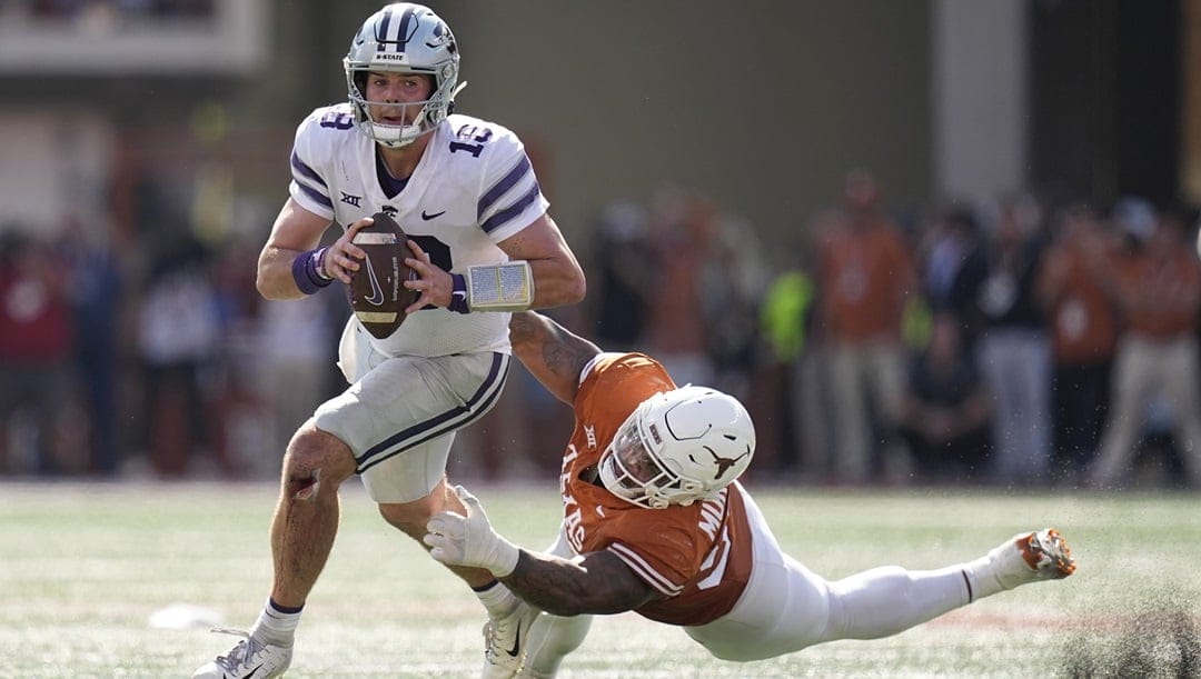 Kansas State quarterback Will Howard (18) is pressured by Texas defensive lineman Byron Murphy II (90) during overtime in an NCAA college football game in Austin, Texas, Saturday, Nov. 4, 2023. Texas coach Steve Sarkisian calls defensive tackles T’Vondre Sweat, an Outland Trophy finalist, and Byron Murphy II the best interior linemen tandem in the country and the anchor for a defense that leads the nation in third down efficiency and red zone defense.