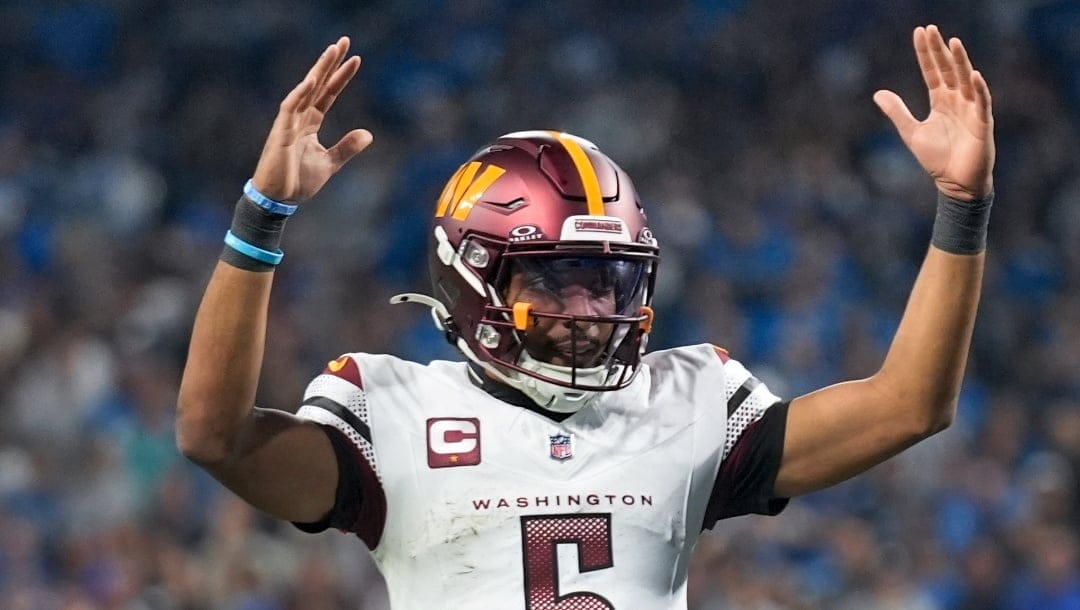 Washington Commanders quarterback Jayden Daniels (5) celebrates a touchdown against the Detroit Lions during the second half of an NFL football divisional playoff game, Saturday, Jan. 18, 2025, in Detroit.