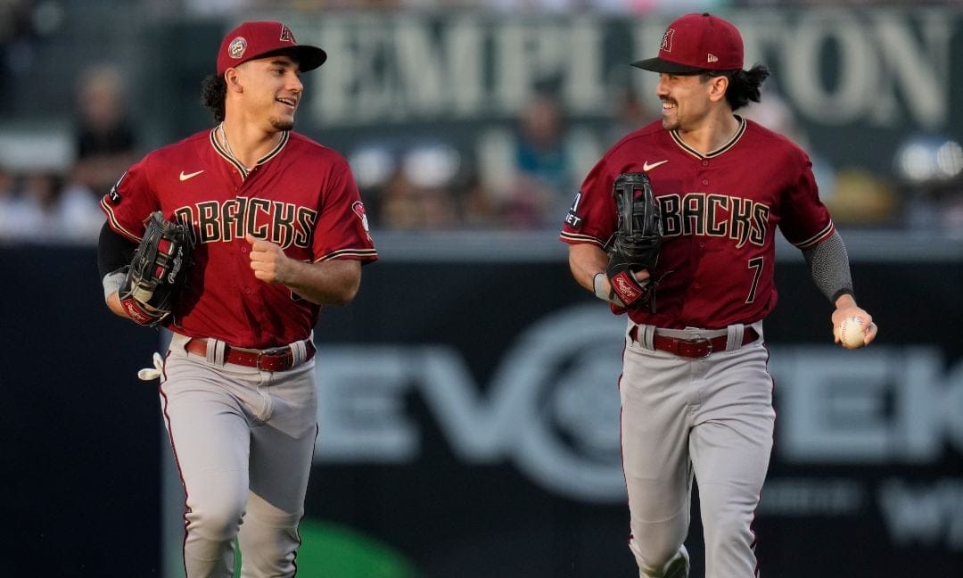 Arizona Diamondbacks center fielder Alek Thomas, left, and right fielder Corbin Carroll joke as they head towards the dugout during the second inning of a baseball game against the San Diego Padres, Friday, Aug. 18, 2023, in San Diego.