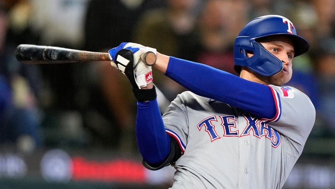 Texas Rangers' Corey Seager follows through during an at-bat in a baseball game against the Seattle Mariners, Saturday, Sept. 30, 2023, in Seattle. (AP Photo/Lindsey Wasson)