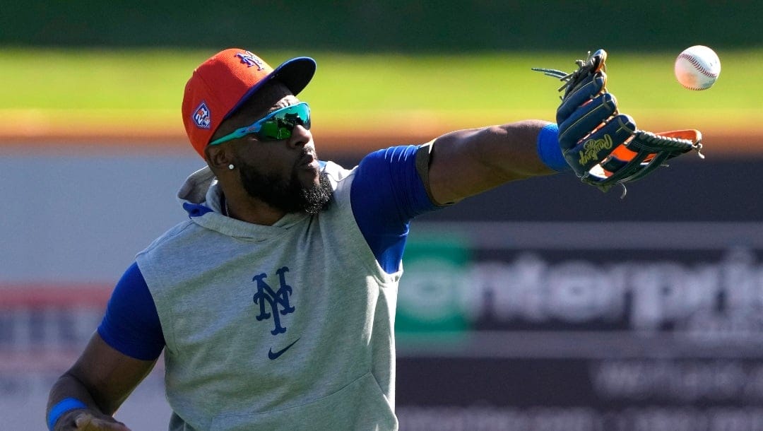 New York Mets' Starling Marte catches a ball during a spring training baseball workout Tuesday, Feb. 20, 2024, in Port St. Lucie, Fla. (AP Photo/Jeff Roberson)