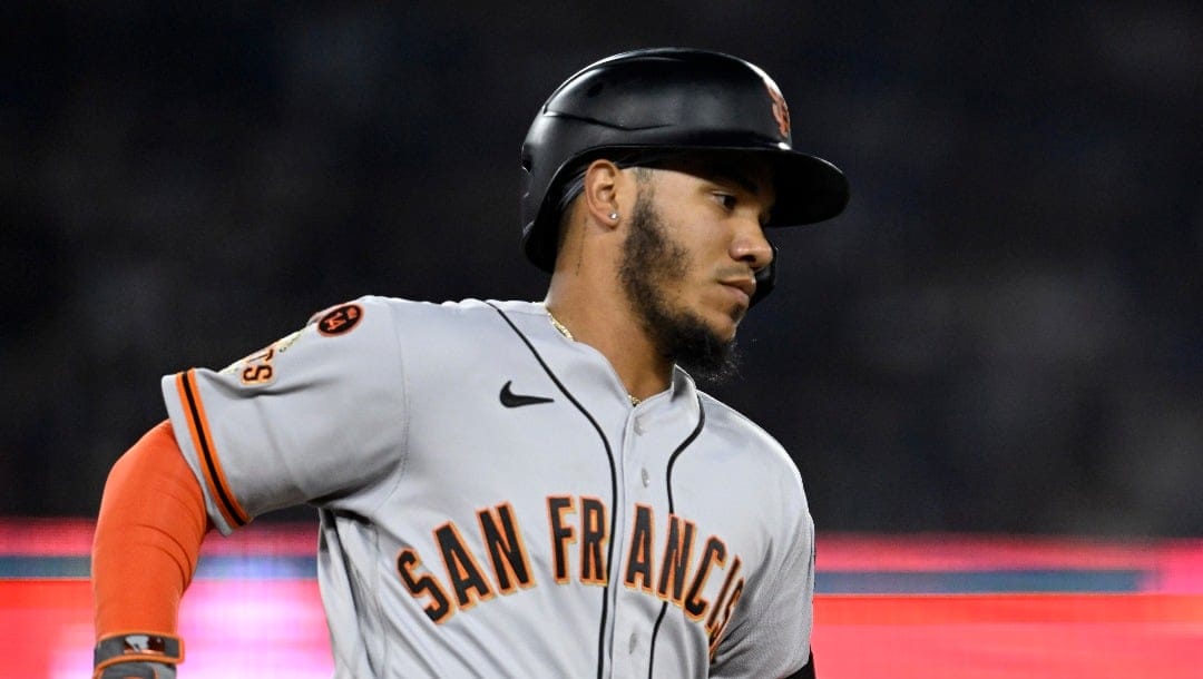 San Francisco Giants' Thairo Estrada rounds first after hitting a solo home run against the Los Angeles Dodgers during the sixth inning of a baseball game in Los Angeles, Friday, Sept. 22, 2023. (AP Photo/Alex Gallardo)