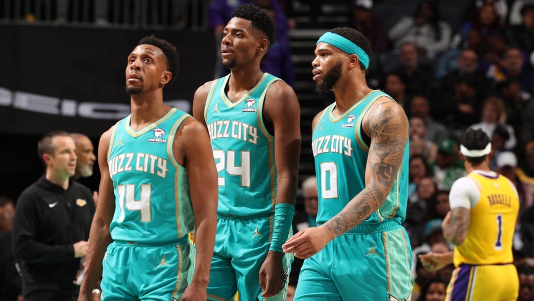 Ish Smith #14, Brandon Miller #24, and Miles Bridges #0 of the Charlotte Hornets looks on during the game against the Los Angeles Lakers on February 5, 2024 at Spectrum Center in Charlotte, North Carolina.