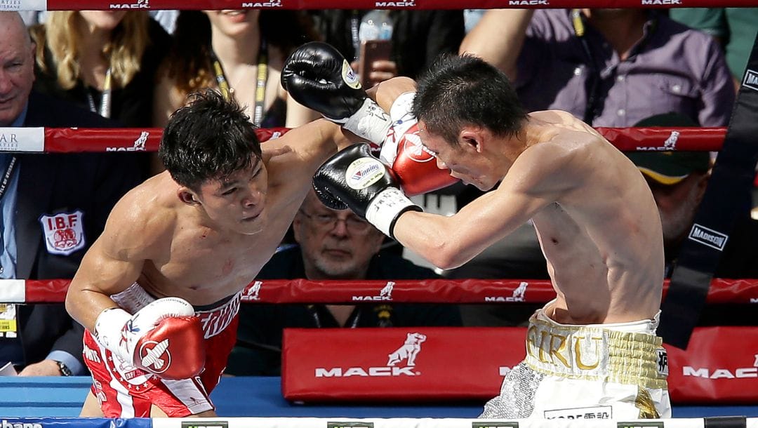 Teiru Kinoshita of Japan, right, and Jerwin Ancajas of the Philippines trade punches during their IBF World Junior Bantamweight title.