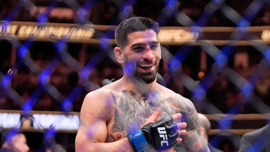 Ilia Topuria celebrates after knocking out Alexander Volanovski during their featherweight bout at the UFC 298 mixed martial arts event.