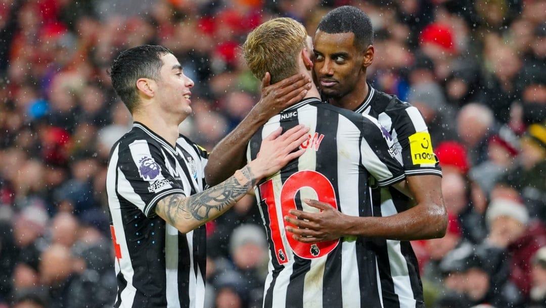 Newcastle's Alexander Isak, right, celebrates with teammates after scoring his side's opening goal during the English Premier League soccer match between Liverpool and Newcastle, at Anfield stadium in Liverpool, England, Monday, Jan. 1, 2024.
