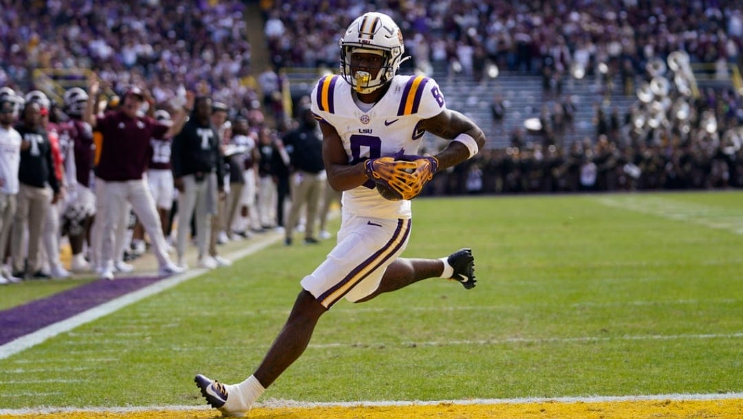 LSU wide receiver Malik Nabers (8) crosses the goal line for a touchdown on a pass reception in the first half of an NCAA college football game against Texas A&M in Baton Rouge, La., Saturday, Nov. 25, 2023.