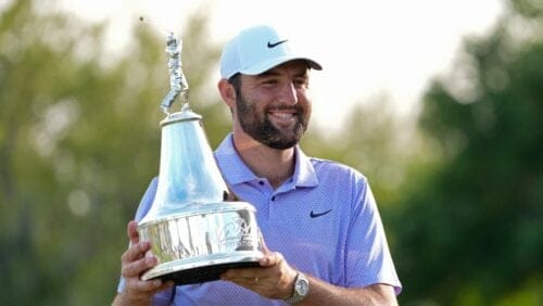 Scottie Scheffler holds the championship trophy after winning the Arnold Palmer Invitational golf tournament Sunday, March 10, 2024, in Orlando, Fla.