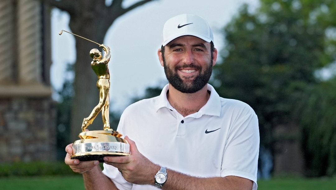Scottie Scheffler holds the trophy after winning The Players Championship golf tournament Sunday, March 17, 2024, in Ponte Vedra Beach, Fla.