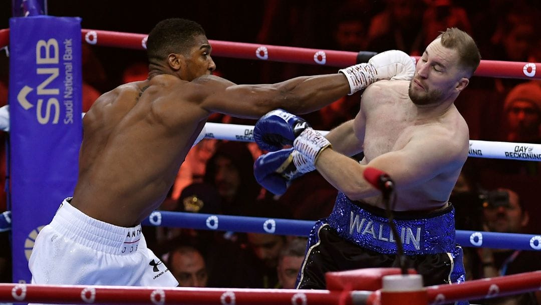 Anthony Joshua, left, and Otto Wallin fight during a boxing match at Kingdom Arena in Riyadh, Saudi Arabia, early Sunday.