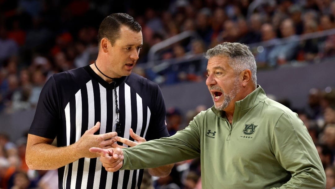 Auburn head coach Bruce Pearl talks with a referee about a call during the second half of an NCAA college basketball game against Kent State, Wednesday, Nov. 13, 2024, in Auburn, Ala. (AP Photo/ Butch Dill)