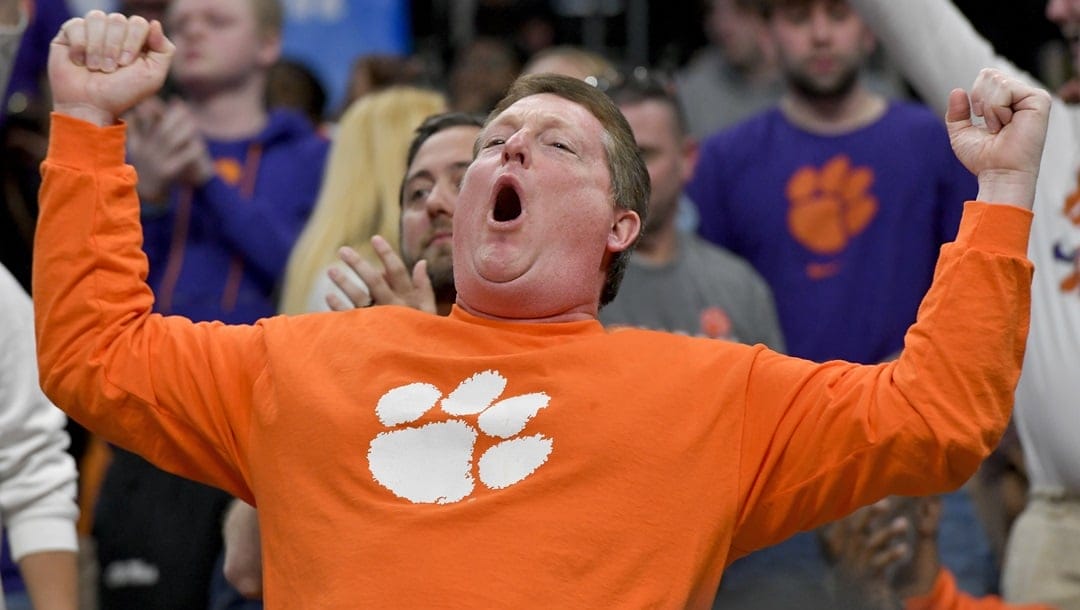 A Clemson fan celebrates the team's 72-64 win against Baylor after a second-round college basketball game in the NCAA Tournament, Sunday, March 24, 2024, in Memphis, Tenn.