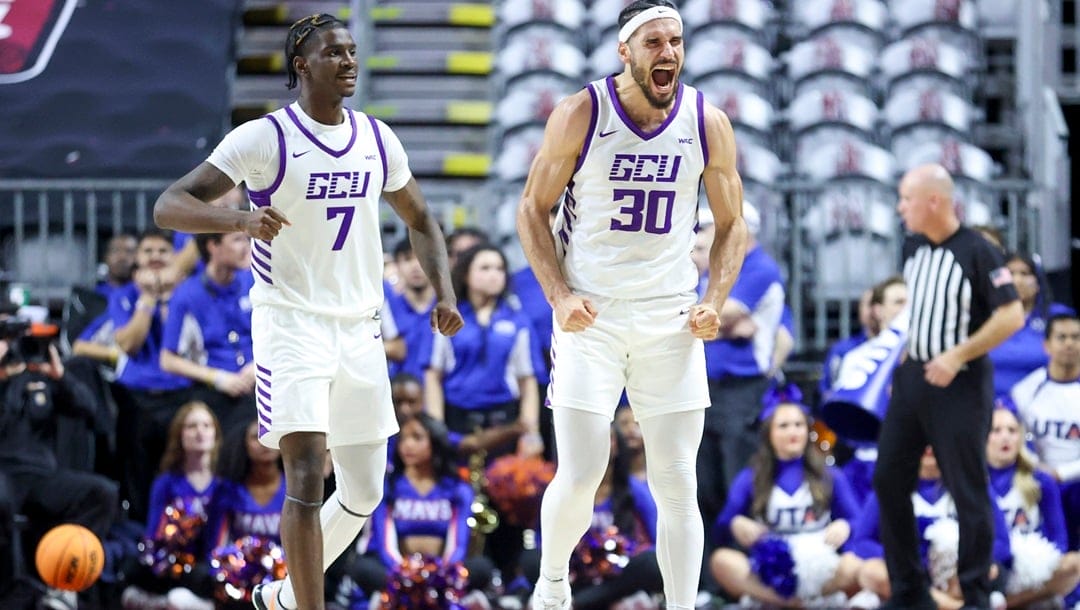 Grand Canyon guard Tyon Grant-Foster (7) and forward Gabe McGlothan (30) celebrate after a Texas-Arlington turnover during the second half of an NCAA college basketball game for the championship of the Western Athletic Conference tournament Saturday, March 16, 2024, in Las Vegas.