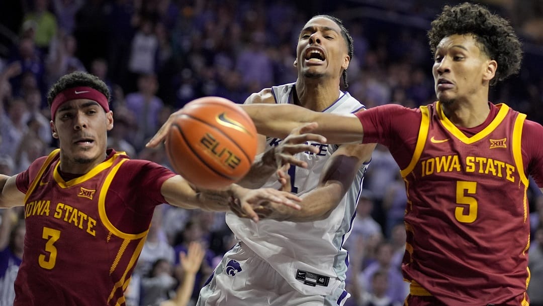 Kansas State forward David N'Guessan, center, chases a rebound with Iowa State guards Tamin Lipsey (3) and Curtis Jones (5) during the second half of an NCAA college basketball game Saturday, March 9, 2024, in Manhattan, Kan. Kansas State won 65-58.