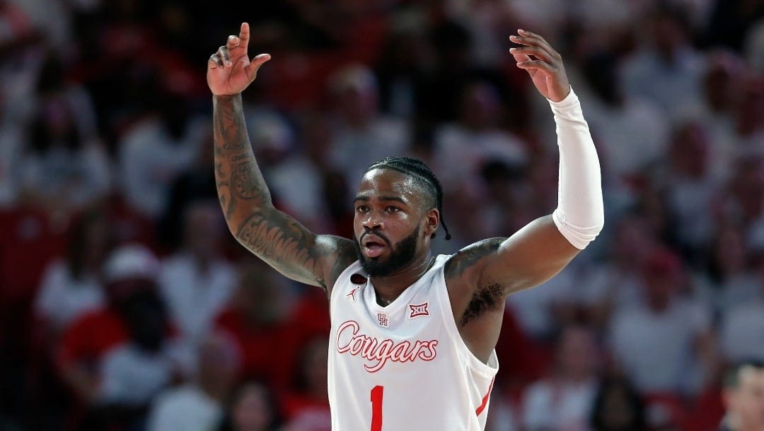 Houston guard Jamal Shead raises his arms to get the crowd up after scoring against Cincinnati during the second half of an NCAA college basketball game Tuesday, Feb. 27, 2024, in Houston. (AP Photo/Michael Wyke)