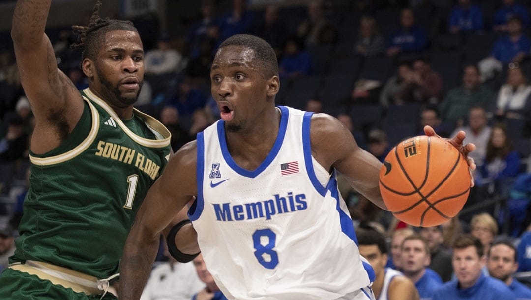 South Florida guard Selton Miguel (1) defends against Memphis forward David Jones (8) during the second half of an NCAA college basketball game Thursday, Jan. 18, 2024, in Memphis, Tenn.