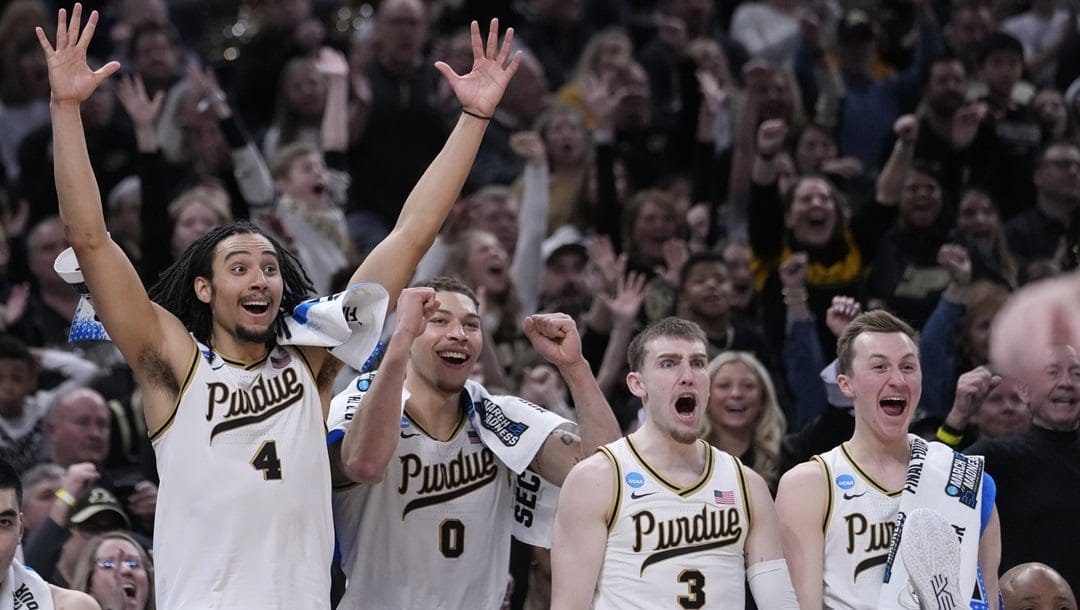 Purdue's Trey Kaufman-Renn (4) celebrates with teammates Mason Gillis (0), Braden Smith (3) and Fletcher Loyer during the second half of a second-round college basketball game against Utah State in the NCAA Tournament, Sunday, March 24, 2024 in Indianapolis.