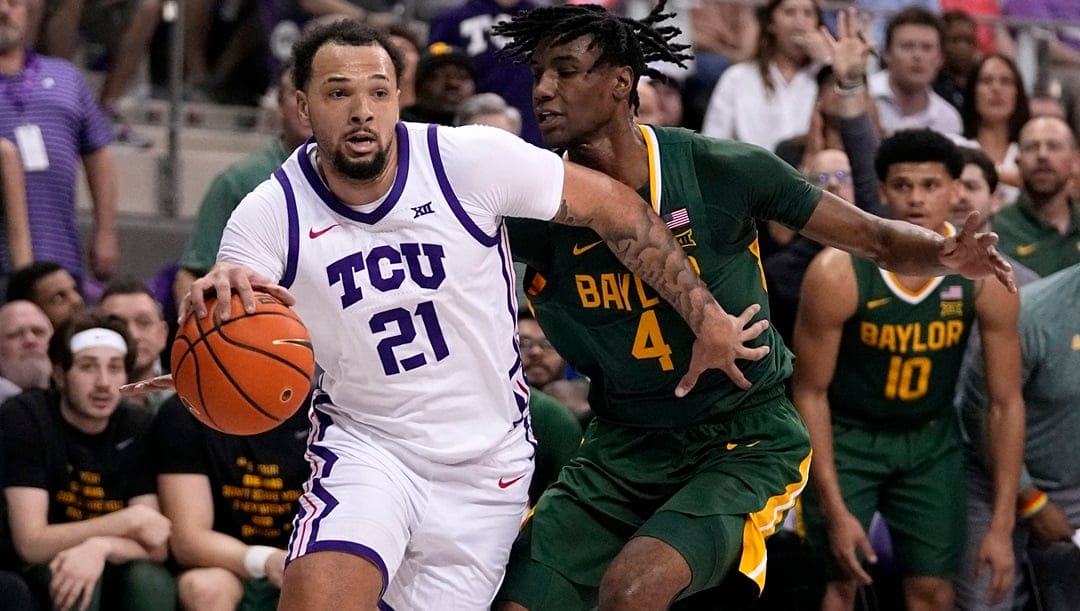 TCU forward JaKobe Coles works to the basket against Baylor's Ja'Kobe Walter (4) in the first half of an NCAA college basketball game in Fort Worth, Texas, Monday, Feb. 26, 2024.