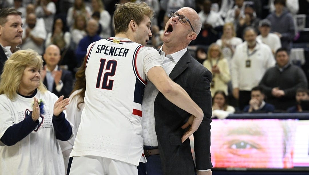 UConn guard Cam Spencer (12) is chest bumped by UConn head coach Dan Hurley as he is introduced for senior ceremony before an NCAA college basketball game against Seton Hall, Sunday, March 3, 2024, in Storrs, Conn.