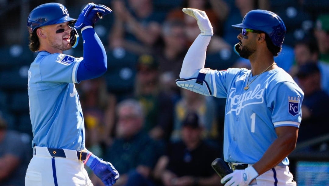Kansas City Royals' Bobby Witt Jr. celebrates his home run with teammate MJ Melendez, right, during the third inning of a spring training baseball game against the Oakland Athletics, Friday, March 1, 2024, in Surprise, Ariz.