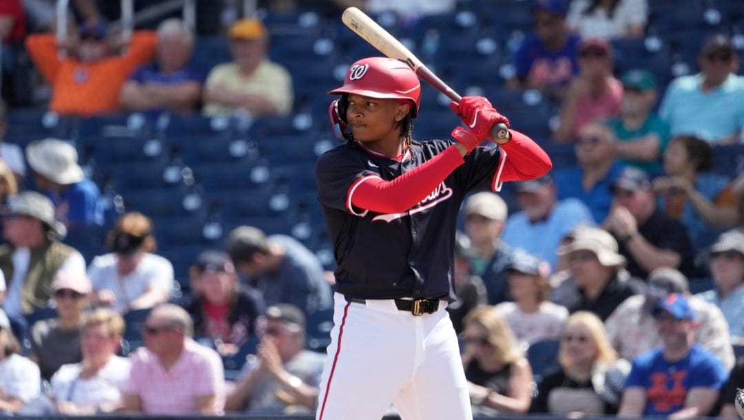 Washington Nationals' CJ Abrams bats during the first inning of a spring training baseball game against the New York Mets in West Palm Beach, Fla.