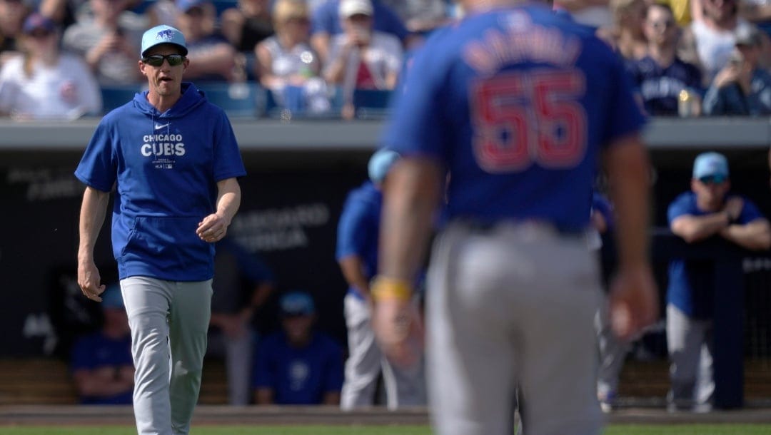 Chicago Cubs manager Craig Counsell walks onto the field for an offensive substitution to put in pinch-runner Luis Vazquez for Miles Mastrobuoni in the fifth inning of a spring training baseball game against the Milwaukee Brewers in Phoenix, Ariz.