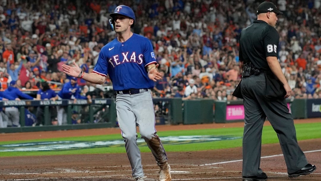 Texas Rangers' Evan Carter reacts after scoring during the second inning of Game 1 of the baseball AL Championship against the Houston Astros Series Sunday, Oct. 15, 2023, in Houston.