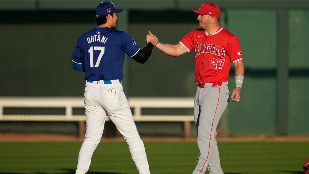 Los Angeles Dodgers designated hitter Shohei Ohtani (17) greets Los Angeles Angels center fielder Mike Trout (27) before a spring training baseball game in Phoenix, Tuesday, March 5, 2024.