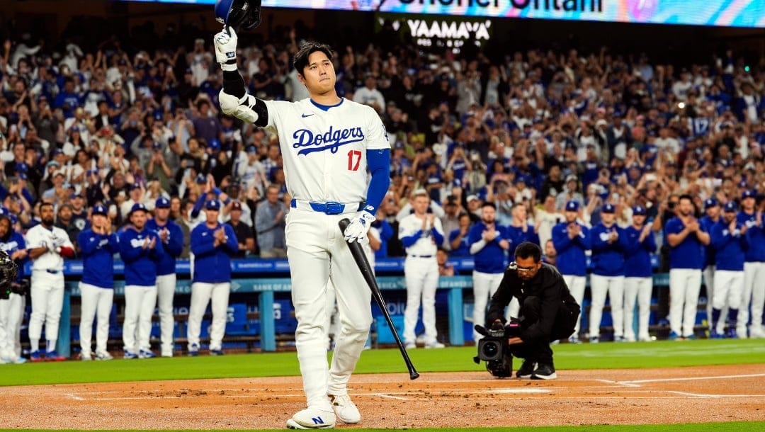 Los Angeles Dodgers designated hitter Shohei Ohtani (17) is honored for being first MLB player to achieve 50 home runs and 50 stolen bases in a single season during the first inning of a baseball game against the Colorado Rockies in Los Angeles, Friday, Sept. 20, 2024.