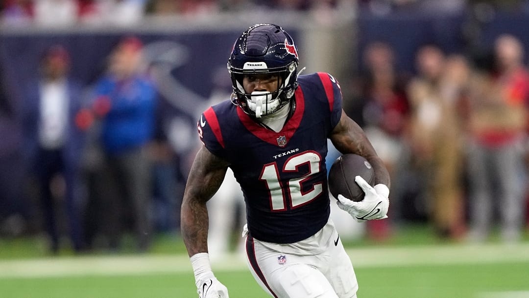 Houston Texans wide receiver Nico Collins (12) runs up the field during an NFL football game against the Cleveland Browns Saturday, Jan. 13, 2024, in Houston. (AP Photo/David J. Phillip)
