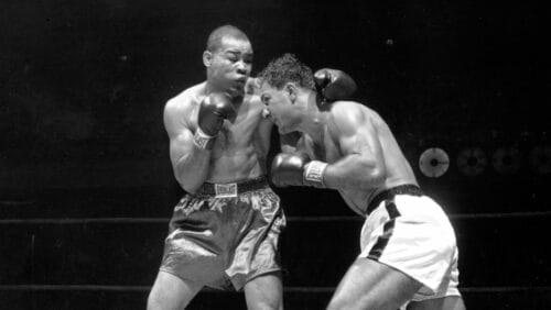 Joe Louis, left, former heavyweight champion, and Rocky Marciano are shown during the 3rd round of their bout.