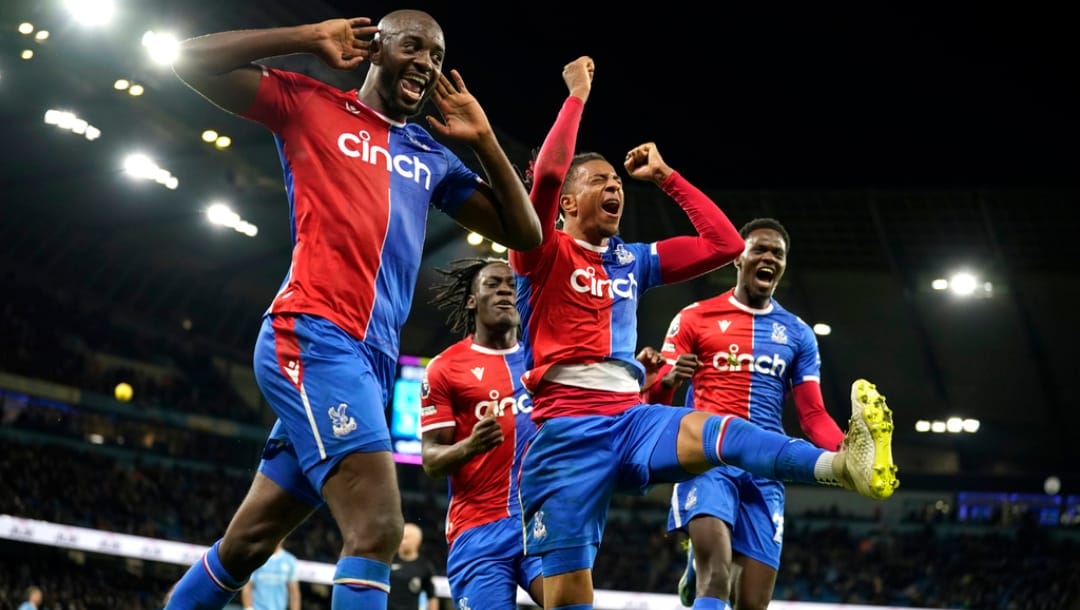 Crystal Palace players celebrate after Crystal Palace's Michael Olise, centre, scored his side's second goal during the English Premier League soccer match between Manchester City and Crystal Palace at the Etihad Stadium in Manchester, England, Saturday, Dec.16, 2023.