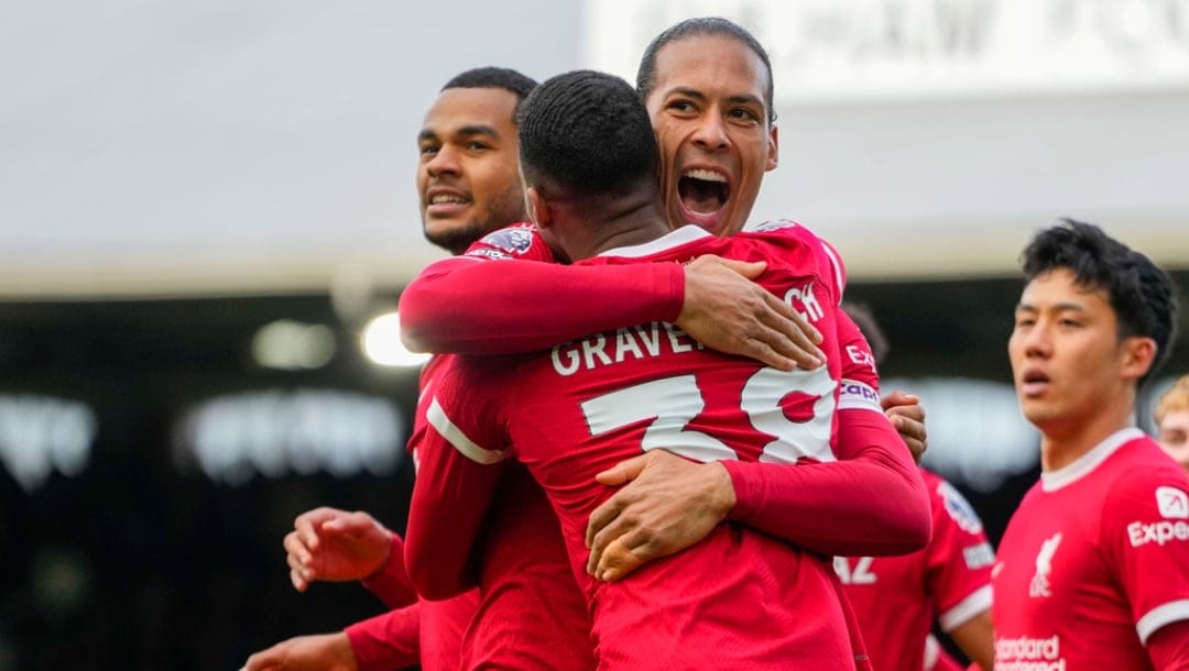 Liverpool's Ryan Gravenberch, front, celebrates with Liverpool's Virgil van Dijk after scoring his side's second goal during the English Premier League soccer match between Fulham and Liverpool at Craven Cottage stadium in London, Sunday, April 21, 2024.