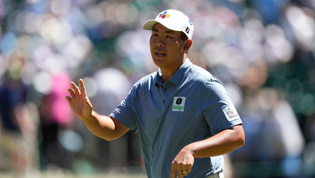 Byeong Hun An, of South Korea, waves after making a putt on the sixth hole during third round at the Masters golf tournament at Augusta National Golf Club Saturday, April 13, 2024, in Augusta, Ga.