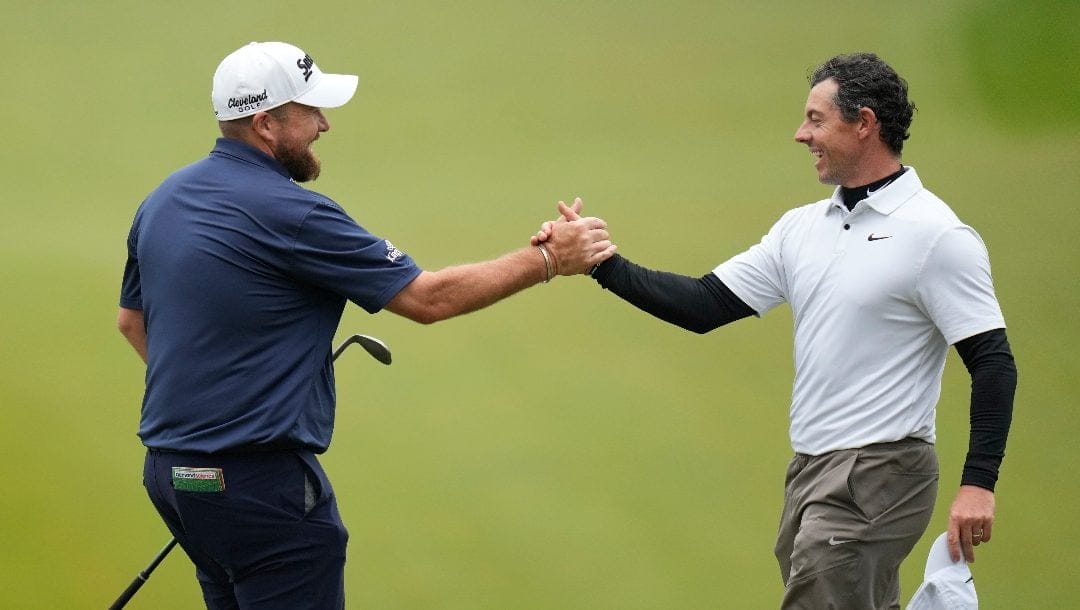 Shane Lowry, of Ireland, shakes hands with Rory McIlroy, of Northern Ireland, on the 18th hole during the third round of the PGA Championship golf tournament at Oak Hill Country Club on Saturday, May 20, 2023, in Pittsford, N.Y.
