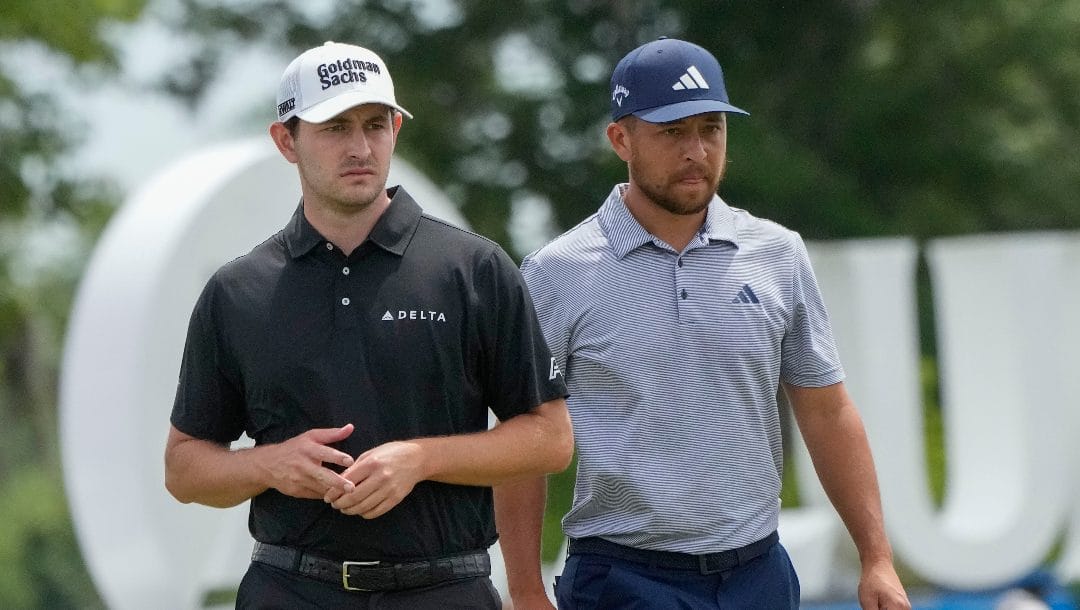 Xander Schauffele, left, and his teammate Patrick Cantlay walk off the 9th green during the second round of the PGA Zurich Classic golf tournament at TPC Louisiana in Avondale, La., Friday, April 21, 2023.