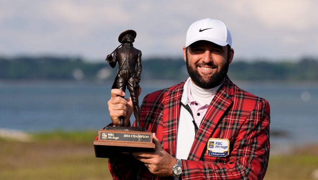 Scottie Scheffler holds the trophy after winning the weather delayed RBC Heritage golf tournament, Monday, April 22, 2024, in Hilton Head Island, S.C.