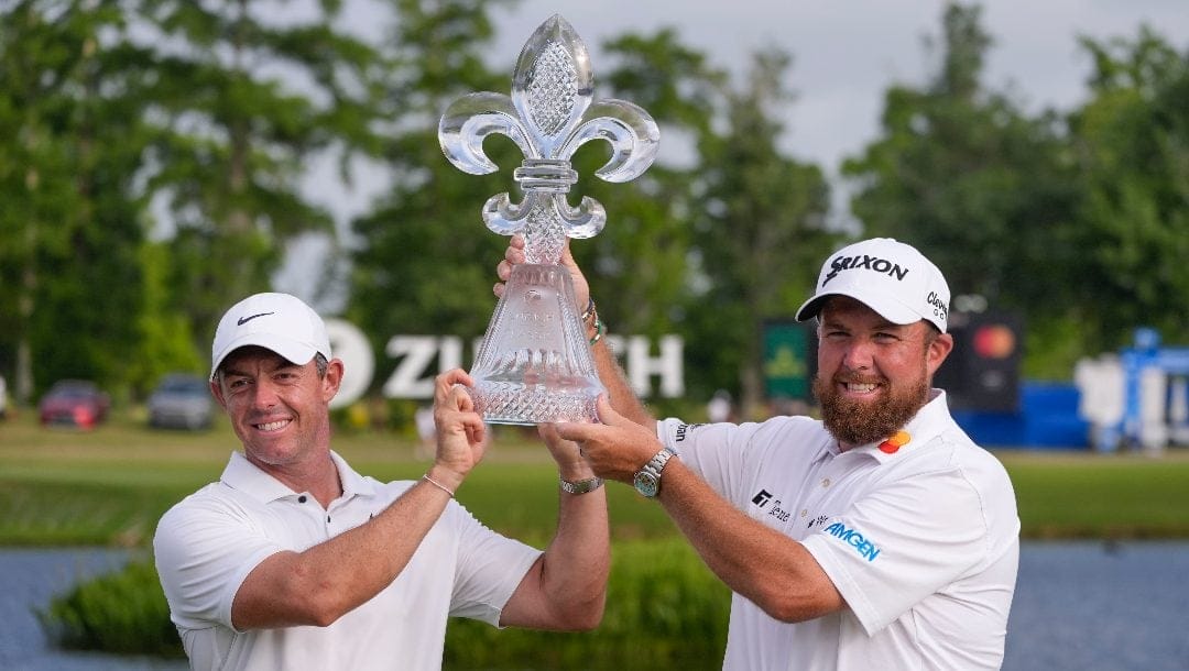 Rory McIlroy, of Northern Ireland, and teammate Shane Lowry, of Ireland, right hold up their trophy after winning the PGA Zurich Classic golf tournament at TPC Louisiana in Avondale, La., Sunday, April 28, 2024.